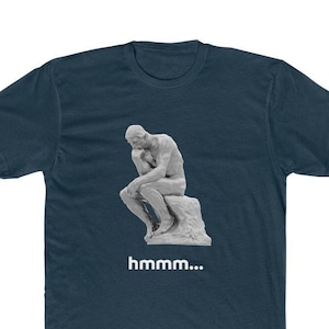 May include: A navy blue t-shirt with a white graphic of the famous "The Thinker" statue. The text "hmmm..." is printed below the statue.