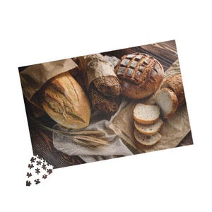 May include: A variety of freshly baked bread, including a round loaf with a crusty exterior, a long loaf with a soft interior, and a baguette sliced into pieces. The bread is arranged on a rustic wooden surface with a brown paper bag and a sprig of wheat.