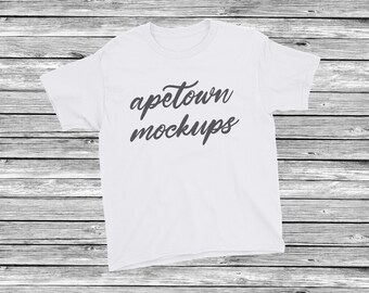 Download Free White Children's Blank T-Shirt Flat Lay Mock Up - Unisex Clothing Mockup - Wood - Vinyl Apparel Display - Product Placement JPG download PSD Template