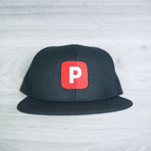 May include: A black and red baseball cap with a white letter "P" in a red square on the front.