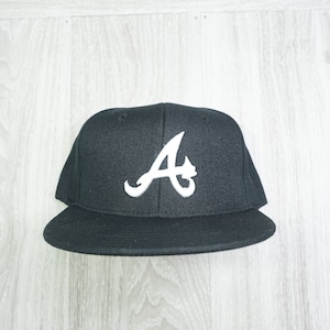 May include: A black baseball cap with a white embroidered "A" on the front.