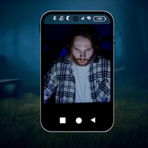 May include: A close-up of a smartphone screen showing a person on a video call. The person is wearing a plaid shirt and has a headset on. The phone is in a dark, foggy environment.