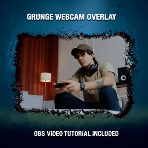 May include: A grunge-style webcam overlay design with a dark blue and black splatter effect. The text "GRUNGE WEBCAM OVERLAY" is displayed at the top, and "OBS VIDEO TUTORIAL INCLUDED" at the bottom. The image features a person holding a game controller.