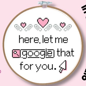 May include: Cross-stitch embroidery hoop with a pink and white pixelated design. The design says "here, let me google that for you." with a pink pixelated search icon and cursor.
