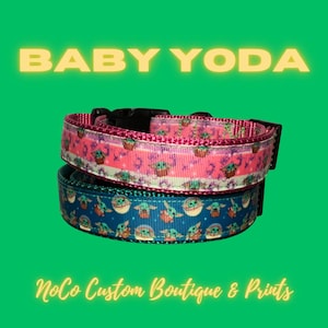 May include: Two dog collars with a Baby Yoda print. The top collar is pink with white and green accents. The bottom collar is blue with white and green accents. The collars are made of fabric and have a black plastic buckle. The text "BABY YODA" is in yellow letters at the top of the image. The text "NoCo Custom Boutique & Prints" is in yellow letters at the bottom of the image.
