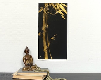 May include: A rectangular art print featuring a vertical gold bamboo stalk illustration on a solid black background. The artwork displays detailed brushstrokes in metallic gold paint, capturing the texture and form of bamboo leaves and stems.