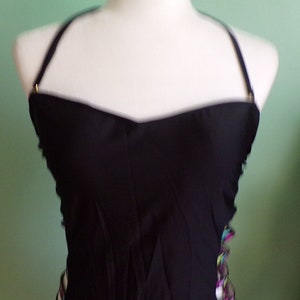 May include: Black strapless swimsuit top with colorful trim along the sides. The trim features a geometric pattern.