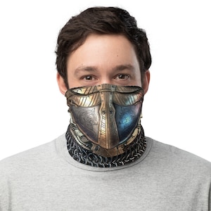 May include: A face mask with a metallic gold and silver design featuring two wolf heads. The mask is made of a soft, breathable fabric and is designed to be comfortable to wear.