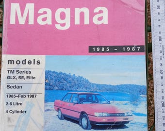 May include: A pink and blue service and repair manual for the Gregory's Automotive Magna, models TM Series, GLX, SE, Elite, Sedan, from 1985-Feb 1987. The cover features a red car and the text "Magna". The manual is from the Monash Public Library.