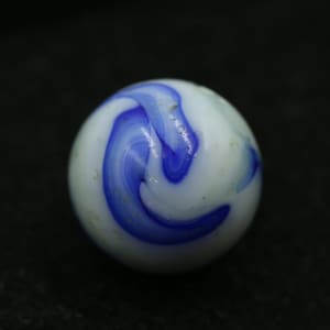 May include: A white marble with a swirling blue design. The glass marble has a glossy finish and is set against a dark background. This classic toy is a traditional game piece.