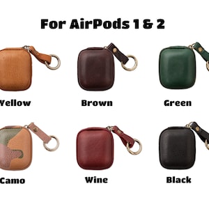 May include: Six different colored leather cases for AirPods 1 & 2. The cases are yellow, brown, green, camo, wine, and black. Each case has a small metal loop for attaching a keychain.