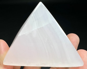 Op de afbeelding: Een witte seleniet piramidekristal. De piramide is glad en heeft een doorschijnende uitstraling.