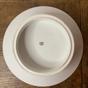 May include: White ceramic cake stand with a raised edge and a green mark on the bottom that reads "Made in Germany"