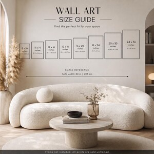 May include: A wall art size guide displays framed art sizes from 8 x 10 inches to 24 x 36 inches, with corresponding metric measurements. The guide includes a scale reference for a sofa width of 80 inches (203 cm). The text reads "WALL ART SIZE GUIDE".