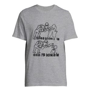May include: A heather grey short-sleeved t-shirt featuring a black line-art graphic of two figures operating machinery. The text reads: LE PATRON A BESOIN DE TOI and TU N'AS PAS BESOIN DE LUI. The design is positioned centrally on the chest of the garment.