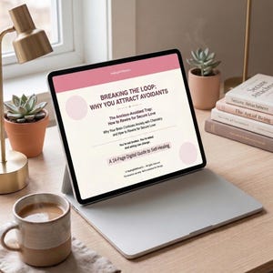 May include: A digital tablet displays the title "BREAKING THE LOOP: WHY YOU ATTRACT AVOIDANTS" with related text. The tablet rests on a laptop, next to a coffee mug, a succulent plant, and books titled "Secure Attachment". The scene is lit by a desk lamp.