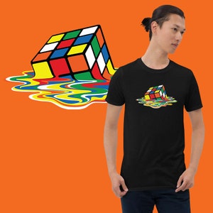 May include: A black t-shirt featuring a graphic of a colourful Rubik's Cube melting into a pool of rainbow-coloured liquid.