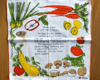 May include: A white linen tea towel with a hand-drawn illustration of vegetables and a recipe for a garden salad with yogurt dressing. The recipe includes ingredients like egg yolk, salt, paprika, lemon juice, and yogurt. The text reads "Garden Salad with Yogurt Dressing. Your favorite garden vegetables washed, sliced and chilled. 1 egg yolk, 1/2 tsp salt, 1/4 tsp paprika, 1/2 cup plain yogurt, 1/4 tsp dry mustard, 1 tbsp lemon juice. Beat egg yolk, salt, mustard and paprika till fluffy. Gradually beat in yogurt and lemon juice. Refrigerate. Spoon over chilled garden vegetables. VE190"