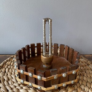 May include: A white ceramic mug with a black handle and the text "But first, coffee" in a black, handwritten-style font. The mug is on a white surface.