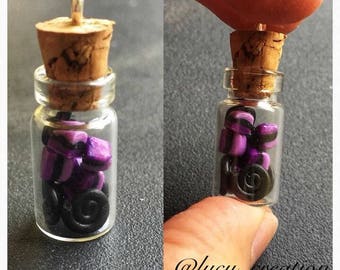 Little clay licorice sweets in glass bottle