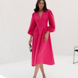 May include: A white ceramic mug with a black handle and the text "But First, Coffee" in a handwritten style. The mug is on a white surface. The mug is approximately 4 inches tall.