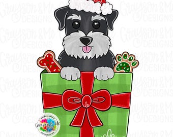May include: A digital illustration of a Schnauzer dog wearing a Santa hat, peeking out of a green gift box tied with a red bow. The box contains a bone-shaped cookie and a paw print cookie. The image has the text "Grayson & Me Designs".