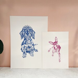 May include: Two illustrations of dogs, one blue and one pink. The blue illustration is of a wirehaired dachshund standing on a white background. The pink illustration is of a chihuahua standing on a white background.