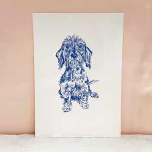 May include: A blue and white line drawing of a small dog with floppy ears. The dog is sitting with its front paws raised and its tail curled behind it.
