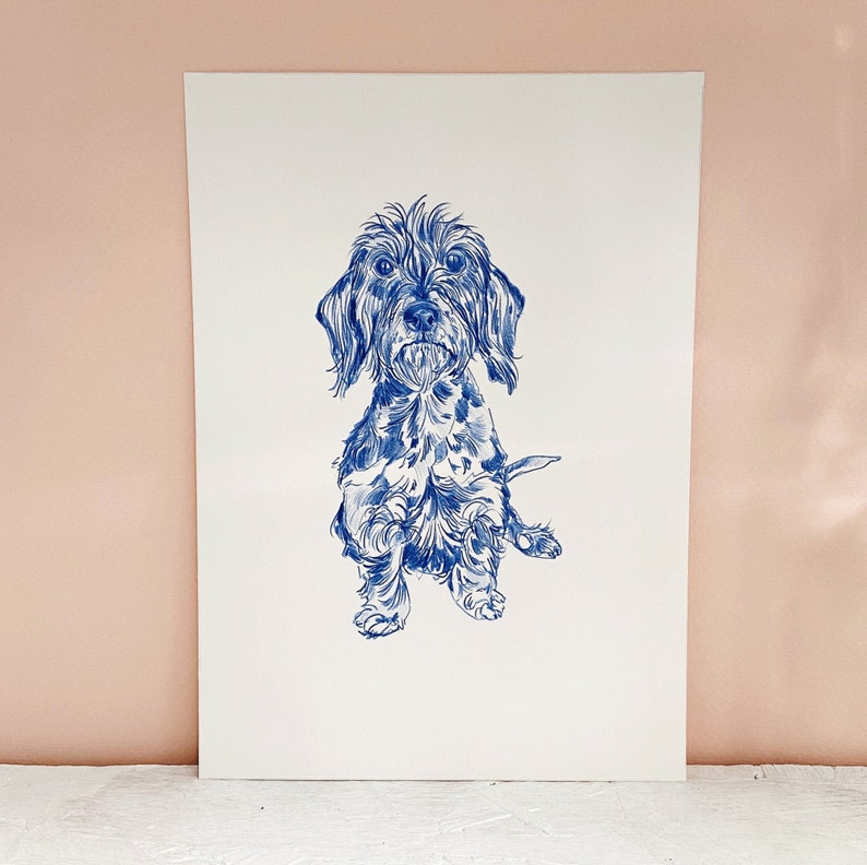 May include: A blue and white line drawing of a small dog with floppy ears. The dog is sitting with its front paws raised and its tail curled behind it.