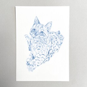 May include: A blue pencil drawing of a cat with a spotted pattern. The cat is looking to the left of the image and has its right paw raised.