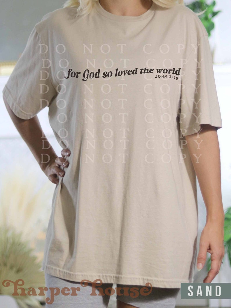 May include: A beige t-shirt with the text "for God so loved the world" and the scripture reference "John 3:16" printed on the front.