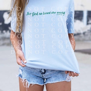 May include: Light blue t-shirt with the text "for God so loved the world" in green lettering and the scripture reference "John 3:16" in smaller lettering.