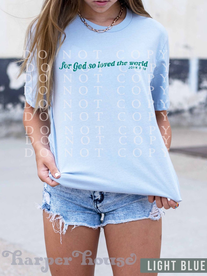 May include: Light blue t-shirt with the text "for God so loved the world" in green lettering and the scripture reference "John 3:16" in smaller lettering.