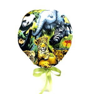May include: A fabric item with a jungle-themed design, showcasing a panda, elephant, zebra, and lion cubs. The colour palette includes green, yellow, and brown, with a light green ribbon tied at the bottom.