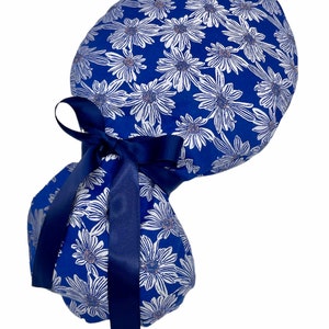Scrub cap, ponytail scrub cap, surgical cap, white daisies on blue, reinforced headband. Choose matching fabric or satin ribbon tie backs.
