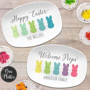 May include: Two white oval serving platters with a pastel colored Easter Peep design. The top platter says "Happy Easter" and "The Millers". The bottom platter says "Welcome Peeps" and "Anderson Family".