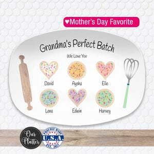 May include: White oval platter with the text "Grandma's Perfect Batch" and "We Love You." The platter features a rolling pin, whisk, and heart-shaped and round cookies with names. The words "Mother's Day Favorite" are at the top.