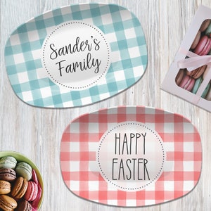 May include: Two oval serving platters with a gingham pattern. One platter is blue and white with the text "Sander's Family" in a circle. The other platter is red and white with the text "Happy Easter" in a circle.
