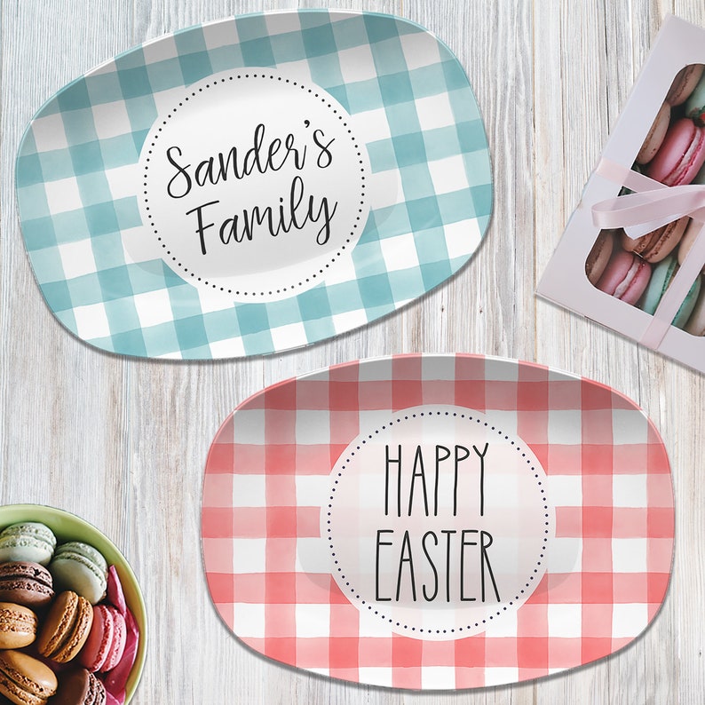 May include: Two oval serving platters with a gingham pattern. One platter is blue and white with the text "Sander's Family" in a circle. The other platter is red and white with the text "Happy Easter" in a circle.