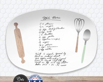 May include: White oval platter with a handwritten recipe for Apple Bars, featuring a rolling pin, whisk, and spoon. The platter includes the text "Our Platter" and "Proudly Made U.S.A. EST. 2017".