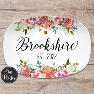 May include: White oval serving platter with a floral design in shades of pink, orange, and green. The text "Brookshire EST. 2022" is printed in black.