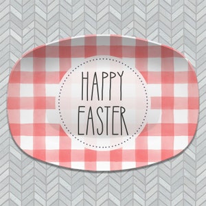 May include: A white oval serving platter with a red and white gingham pattern. The center of the platter has a circle with the text "Happy Easter" in black.