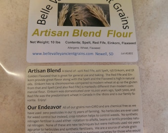 May include: A 10-pound bag of Belle Valley Ancient Grains Artisan Blend Flour. The bag is white with a brown label that lists the ingredients: Spelt, Red Fife, Einkorn, and Flaxseed. The label also states that the flour is non-GMO and chemical free. The bag is sitting on a wooden surface.