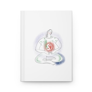 Könnte beinhalten: Ein weißes Notizbuch mit festem Einband und einer Strichzeichnung einer Person im Schneidersitz. Die Figur trägt ein rot-weißes Yin-Yang-Symbol auf dem Oberkörper, umgeben von sanften grünen und blauen Aquarellakzenten auf dem Cover.