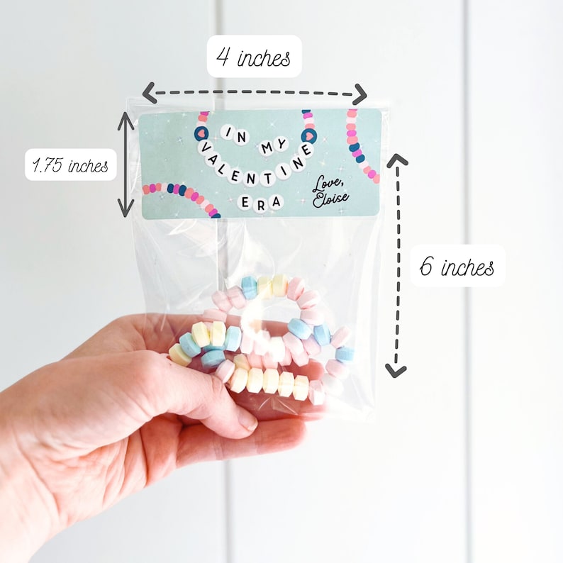 May include: A clear plastic bag containing pastel-colored candy bracelets. The bag has a label that reads "IN MY VALENTINE ERA" with a decorative necklace design. The label is 4 inches wide and 1.75 inches tall. The bag is 6 inches tall.