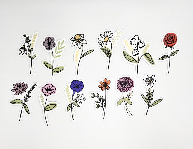 May include: A set of 12 flower stickers featuring various floral designs in pink, purple, blue, yellow, orange, red, and white. The stickers are outlined in black and have a white background.