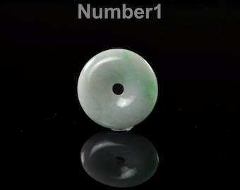 May include: A round, pale green jade pendant with a central hole. The jade has subtle green veining and is set against a black background. The word "Number1" is in white text at the top.