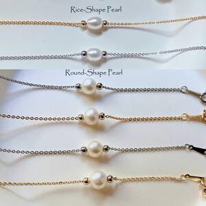 May include: Four delicate necklaces with pearl accents. Two necklaces feature round pearls and two feature rice-shaped pearls. Each necklace has a gold or silver chain.