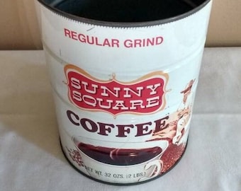 May include: A vintage metal coffee can with a white background and red and black lettering. The can says "Sunny Square Coffee" and "Regular Grind". The can has a picture of a cup of coffee and a net weight of 32 ounces or 2 pounds.