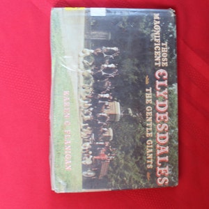 May include: A book cover featuring a photograph of a team of Clydesdale horses pulling a wagon. The book title is "Those Magnificent Clydesdales - The Gentle Giants" by Karen O'Flanigan.